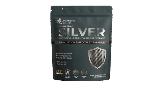 Plantidote root supplement package on a table with a plant in th